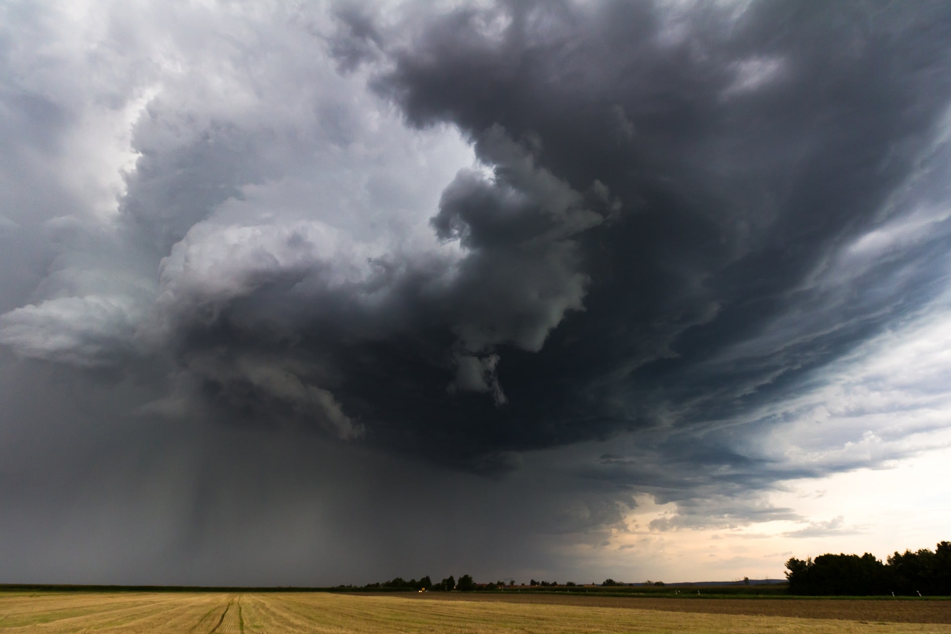 thunderstorm clouds over cropfield