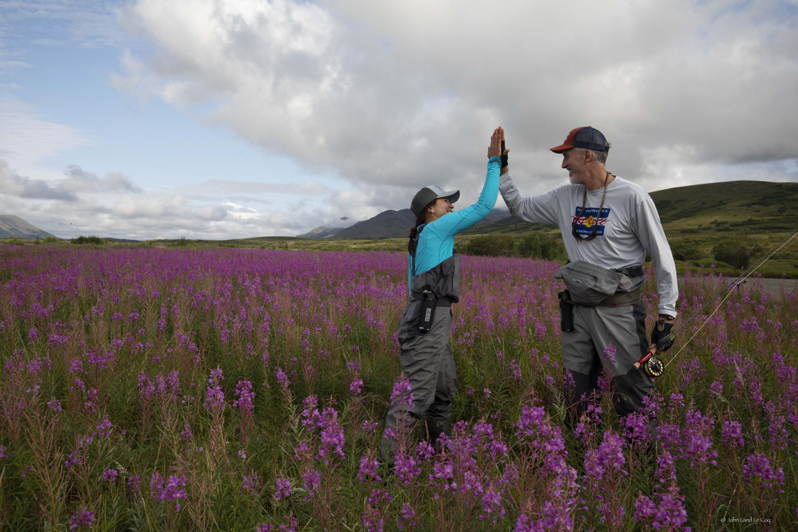 anya and max high five in a field