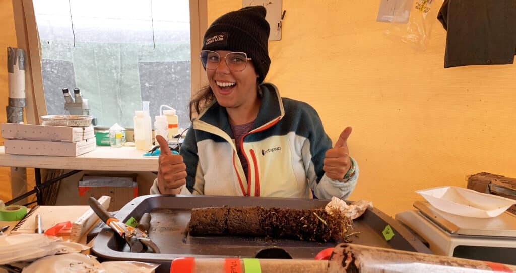 Esmeralda Torres Martínez poses in front of a permafrost core