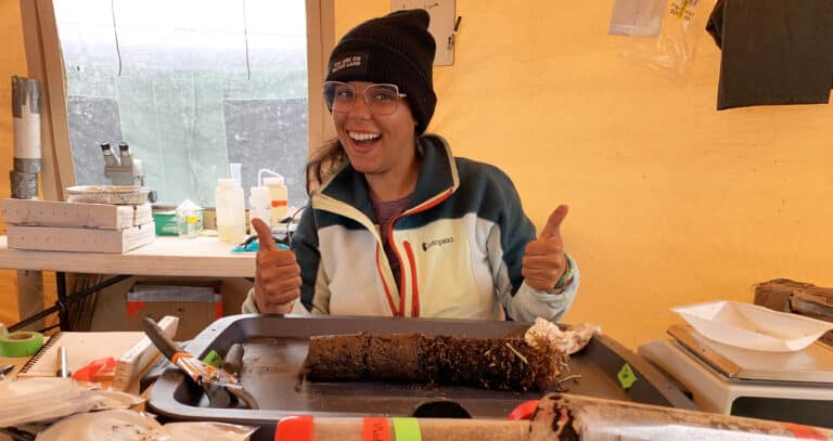 Esmeralda Torres Martínez poses in front of a permafrost core