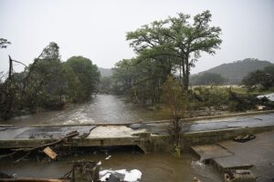 a bridge road in Texas damaged by flooding