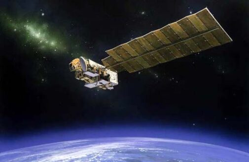 a satellite with a large panel wing orbits above Earth's atmosphere