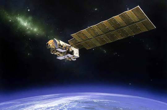 a satellite with a large panel wing orbits above Earth's atmosphere
