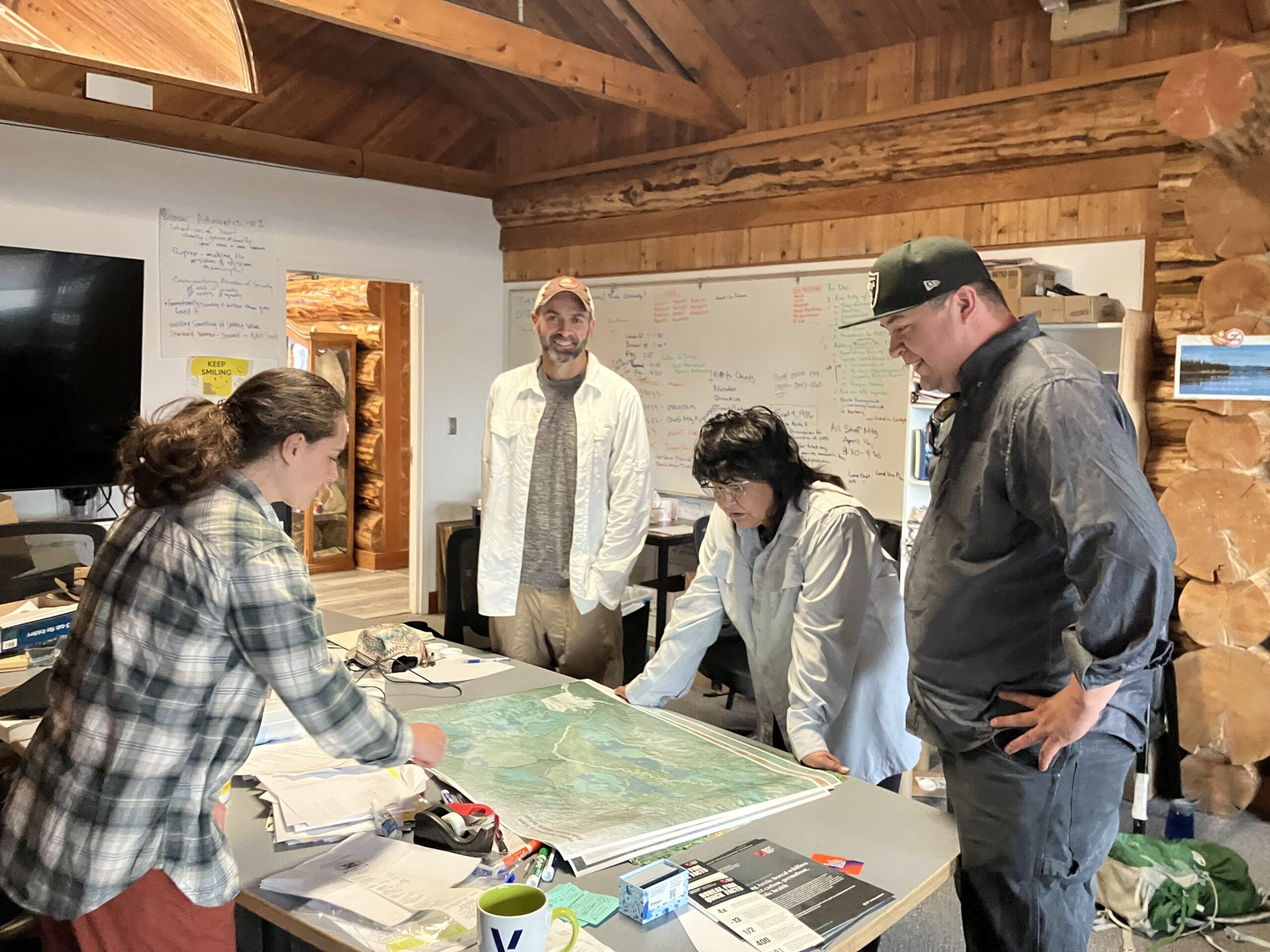 mathes, rogers, adams and alexander lean over a map showing yedoma permafrost in alaska