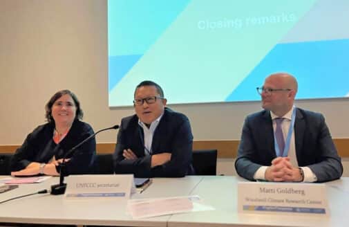 Matti Goldberg sits in front of a presentation screen with fellow presenters on a panel at bonn 2025
