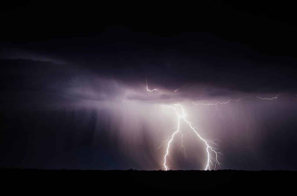 lightning lights up a dark stormy sky
