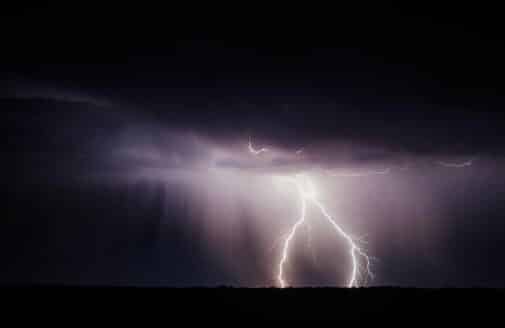 lightning lights up a dark stormy sky