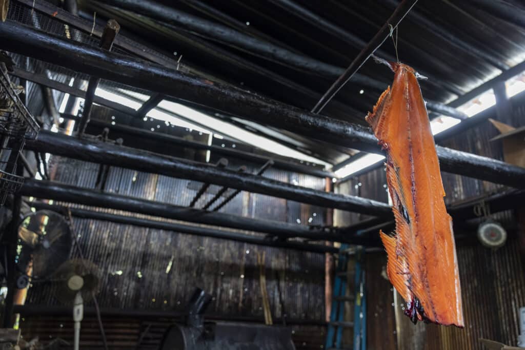 King salmon backbone hangs in a smokehouse.
