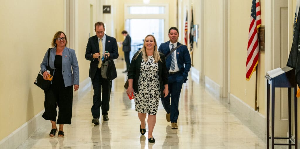 Woodwell Climate staff walking down a Capital hallway facing the camera.