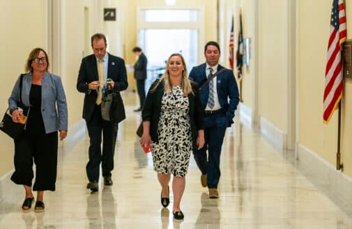 Woodwell Climate staff walking down a Capital hallway facing the camera.
