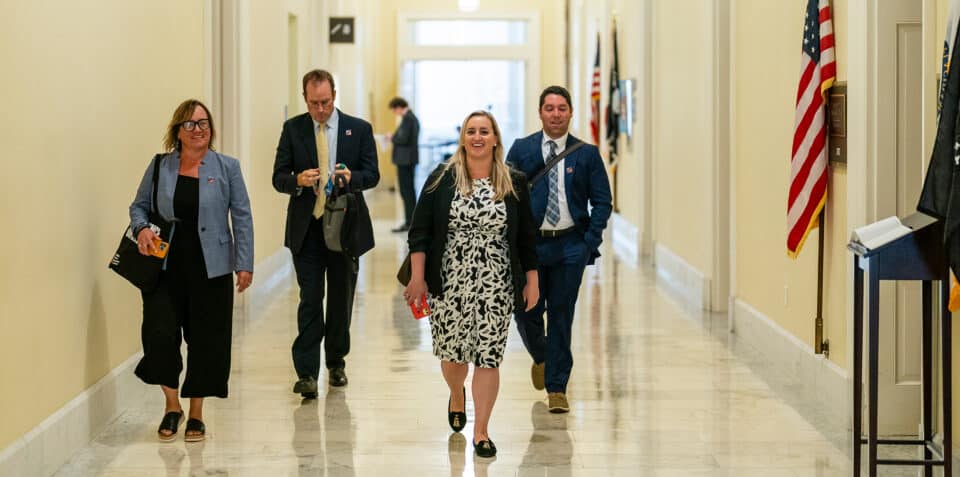 Woodwell Climate staff walking down a Capital hallway facing the camera.