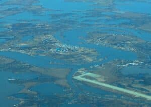 aerial photo of Nunapitchuk, located on a peninsula and surrounded by water. there is also a runway on a nearby peninsula