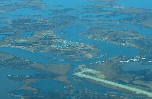 aerial photo of Nunapitchuk, located on a peninsula and surrounded by water. there is also a runway on a nearby peninsula