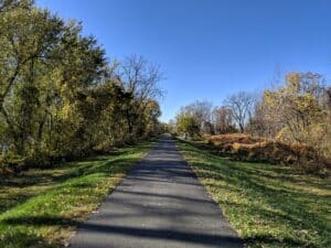 a bike path runs atop a levee into the distance