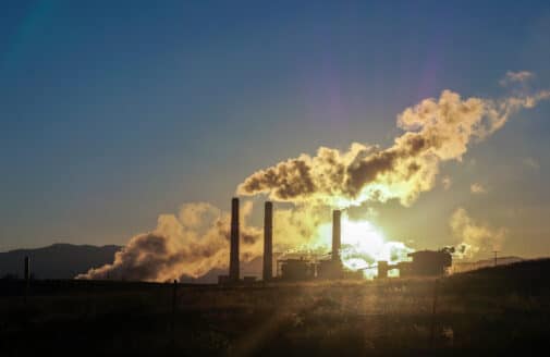 sunset light through smokestack haze