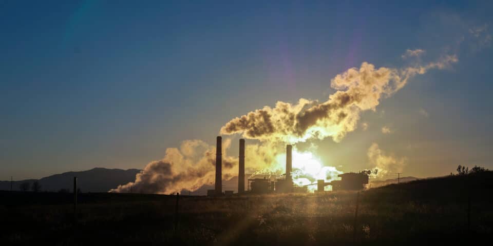 sunset light through smokestack haze