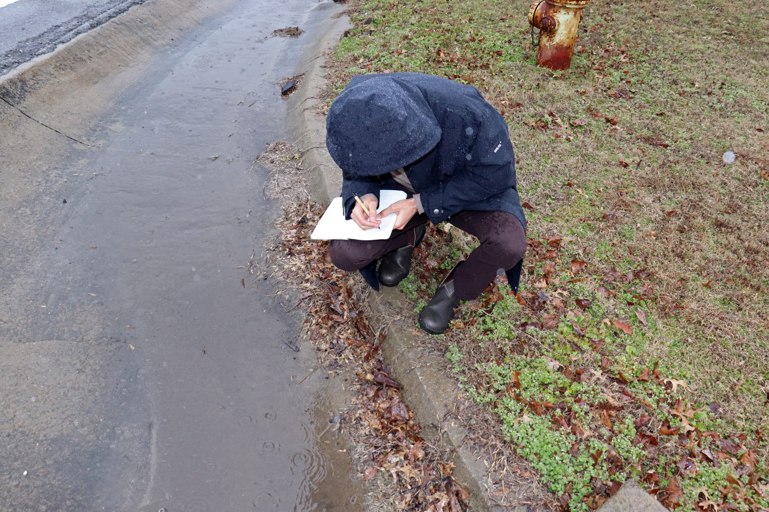 Dominick Dusseau takes notes on flooding patterns in Stanton, TN