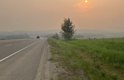 haze from wildfires over road in alaska