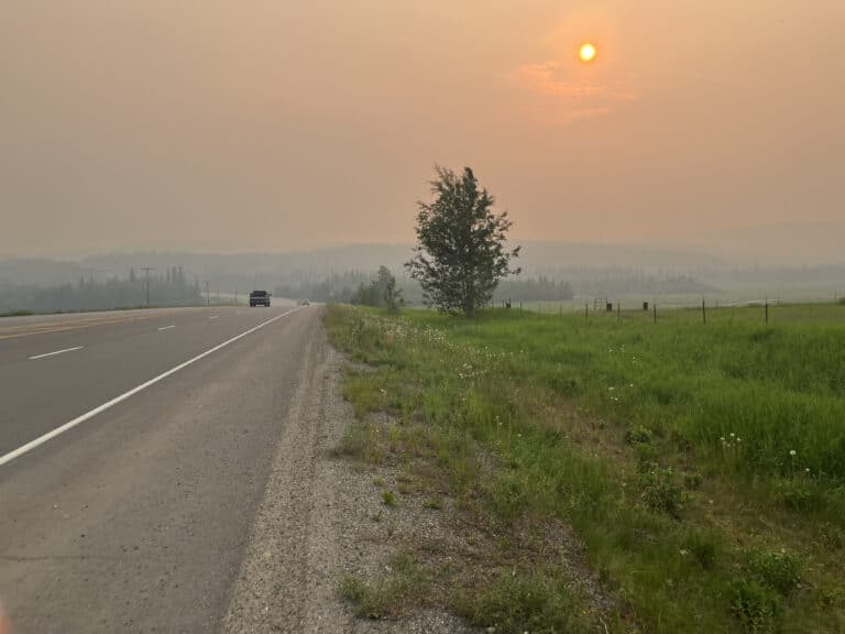 haze from wildfires over road in alaska