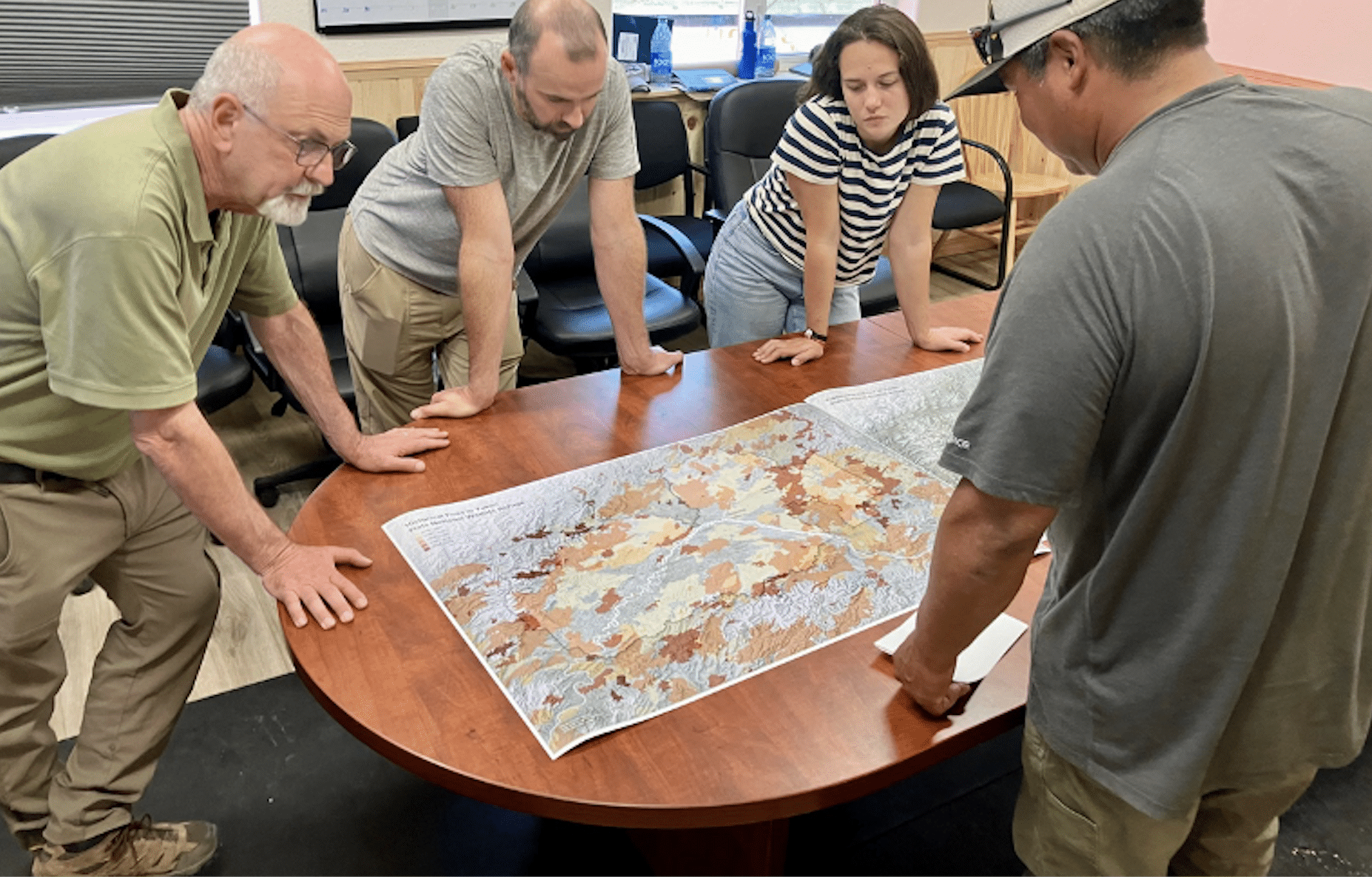peter frumhoff, brendan rogers, and kayla mathes present maps during community visit to yukon flats