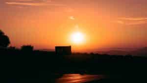 a sunset in an orange sky over a dark skyline