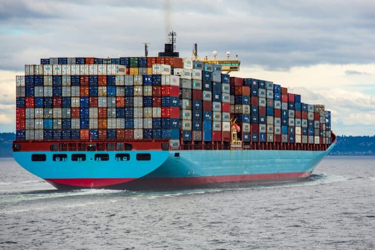 a large boat stacked tall with shipping containers